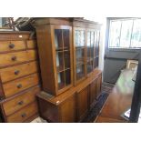 A George III style mahogany breakfront bookcase with four glazed doors above four panelled doors on