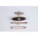 A Victorian gold mourning brooch and three other gold brooches.
