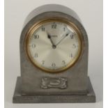 A Tudric hammered pewter mantle clock, impressed no 5050, height 16cm, width 14.2cm.