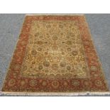 An Indian carpet, the cream field with an all over design of flowering vines, leaves and palmettes,