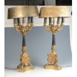 A pair of gilt metal and black painted table lamps, with four arms on a fluted tapering stem,
