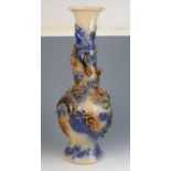 A Japanese pottery baluster vase, moulded with stylised dragons,
