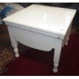 A Victorian white painted commode on turned feet.