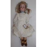 A porcelain head doll, the head with sleep eyes, open mouth, teeth and pierced ears,