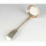 An Exeter silver Victorian sugar sifting spoon in plain fiddle pattern.