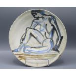 A studio pottery shallow bowl by Rodney Edmund Simpson, decorated with a naked woman,