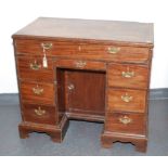 A George III mahogany kneehole desk,