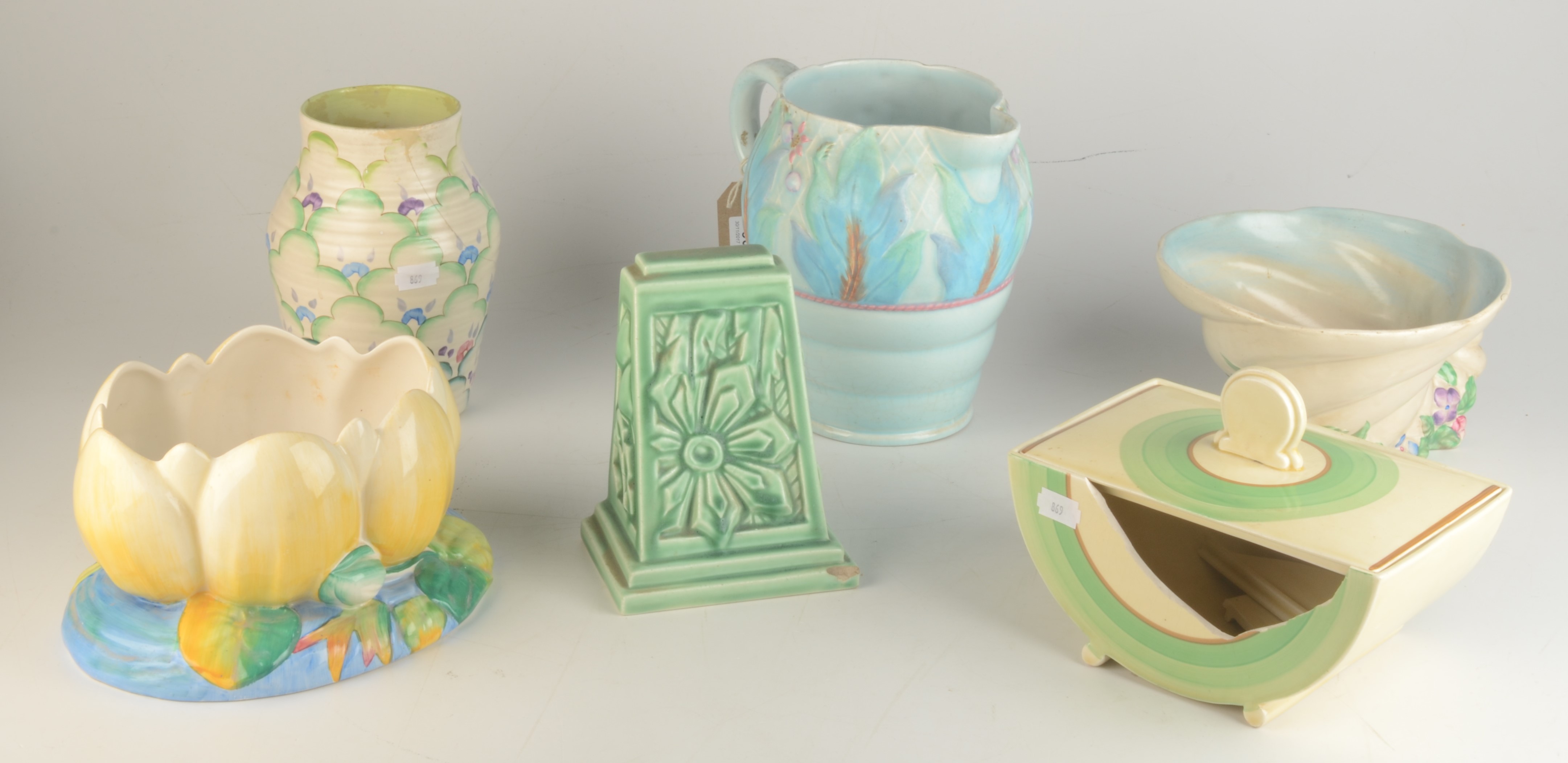 Miscellaneous Clarice Cliff, comprising two planters, a jug, a vase and three other items.