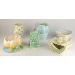 Miscellaneous Clarice Cliff, comprising two planters, a jug, a vase and three other items.