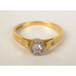 An 18ct. gold ring set a solitaire diamond and diamond shoulders.