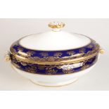 A 19th century oval porcelain tureen and cover, the blue bands gilt decorated with foliage,