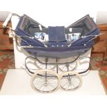 A twin pram in blue coachwork with central cover and chrome fittings, full height approximately 36".