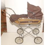 A 1970s small pushchair/pram by Swallow with folding base and detachable top, full height 34".