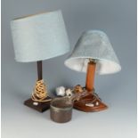 A 1930s walnut table lamp on a quarter round base mounted with a model bird,