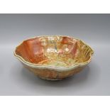 A Ruthanne Tudball orange glazed stoneware bowl, height 6.5cm, diameter 16.5cm.