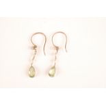 A pair of peridot and pearl earrings.