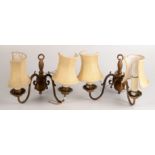 A pair of gilt metal twin branch wall light fittings with shades.