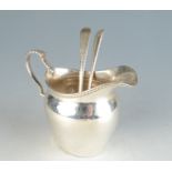 A pair of Georgian shell bowl feather edge silver teaspoons and a Georgian style silver cream jug.