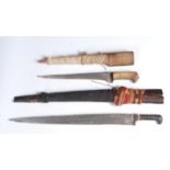 Two middle eastern short swords, each with a horn handle and wooden sheath, lengths 70cm and 41.5cm.