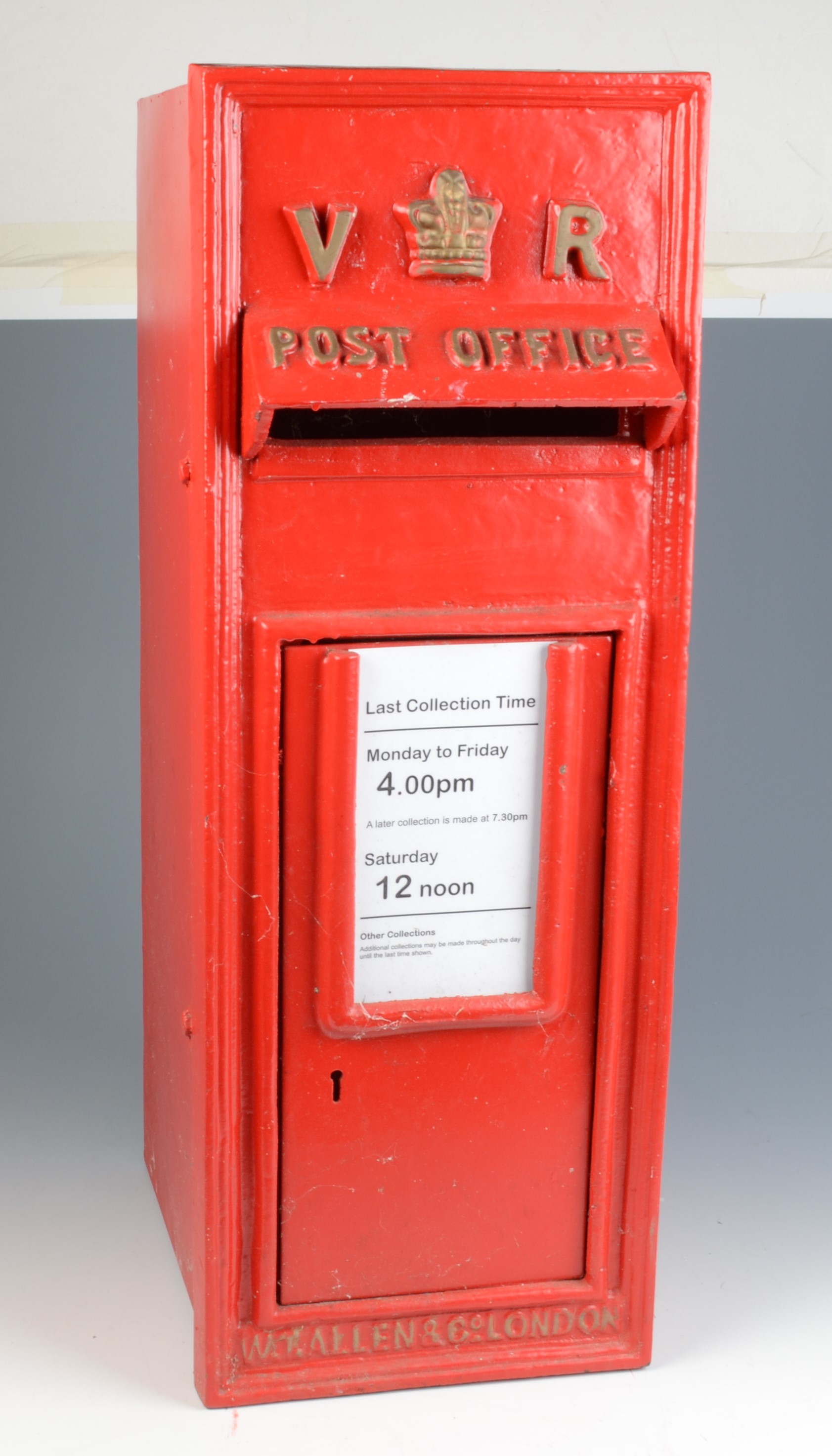 A reproduction V.R. red painted post box, inscribed 'W.T. Allen & Co.