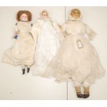 Three shoulder plate wax head dolls, two with inset eyes, one with sleep eyes,