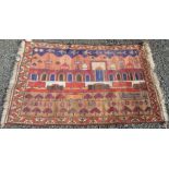 An Afghan rug, decorated with aeroplanes, a mosque, tanks and trains,