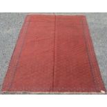 A Turkoman style flatweave rug, with rows of diamond shaped motifs enclosing hooked guls,