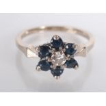 A sapphire and diamond flower head post war cluster ring.