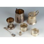 A heavy engine turned silver napkin ring, a drum mustard, a christening mug and an egg cup etc. 7.