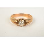 A late Victorian 18ct gold ring claw set a diamond.