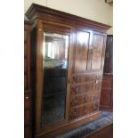 An Edwardian mahogany crossbanded wardrobe, with a pair of blind doors above four drawers,
