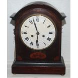 An Edwardian inlaid mahogany mantel clock, the arched top above an 18cm white enamelled dial,