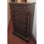 A Victorian carved oak Wellington chest, with seven drawers on a plinth base, height 136cm,