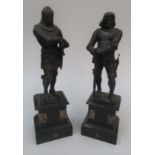 A pair of spelter figures of knights, 19th century, on black slate and marble plinth bases,