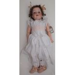 A porcelain head doll, the head with sleep eyes, open mouth and teeth,