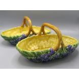 A pair of 'Sarreguemines France' oval pottery baskets, decorated to the exterior with flowers,