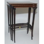 A mahogany nest of three tables, each satinwood crossbanded top with shell inlay to the centre,