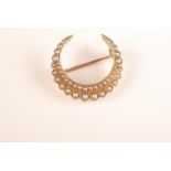 A good pearl set Victorian gold crescent brooch.