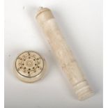 An ivory needle case in the form of a canon, 9cm, and an ivory needle wax box.