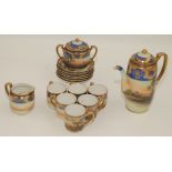 A Noritake porcelain coffee set, gilt decorated with river scenes, height of pot 17cm.
