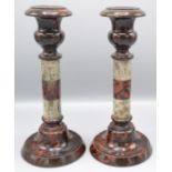 A pair of Cornish serpentine candlesticks, with urn form sockets, banded shafts on circular bases,