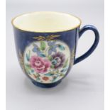 A Worcester porcelain cup, 18th century, the blue ground with a pair of oval cartouches,