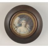 A portrait miniature of a fashionable lady apparently dated 1789, diameter 6.2cm.