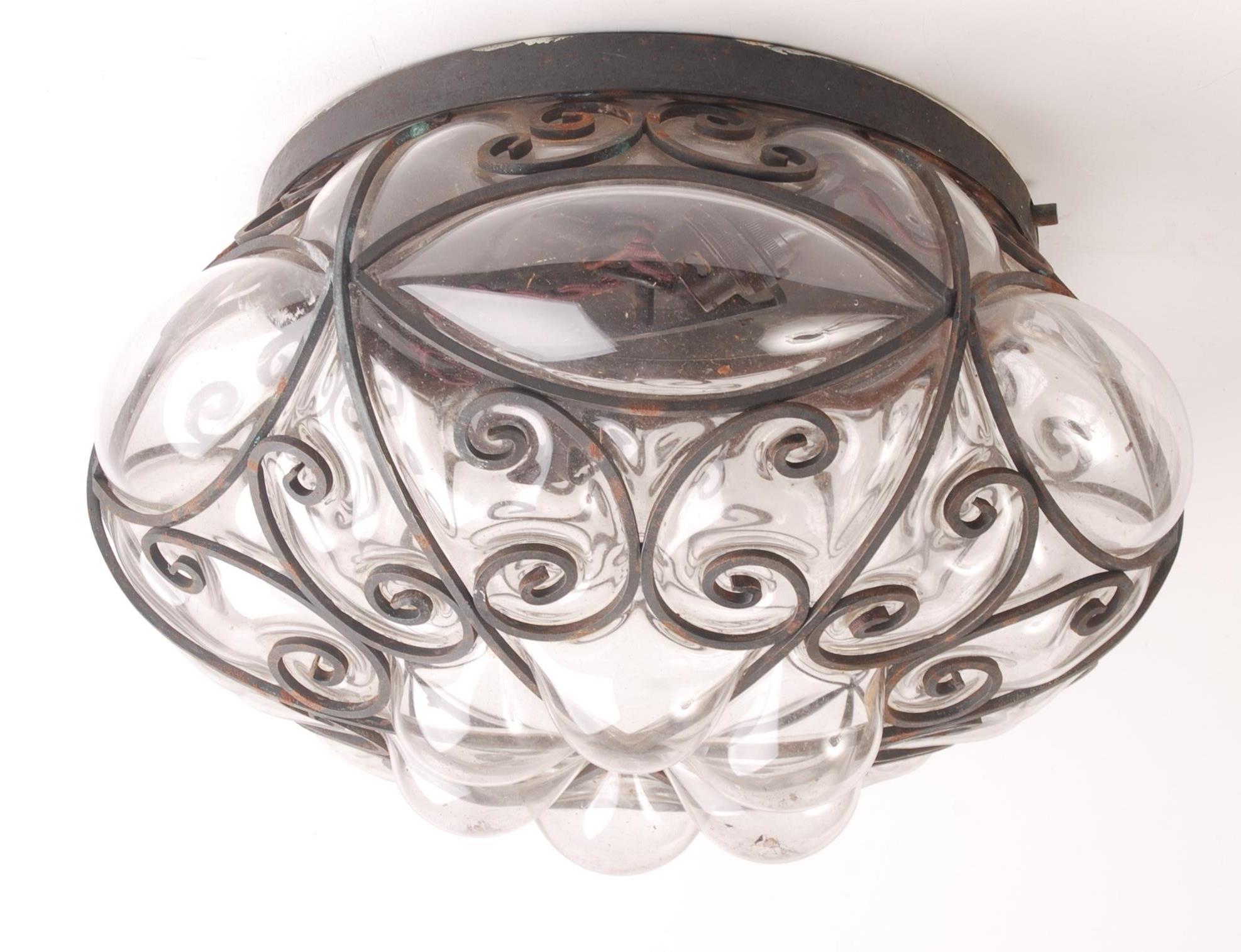 A glass and wrought iron light fitting, diameter 32cm.