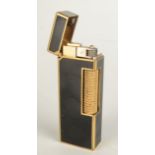 A gold plated and black lacquer Dunhill gas made in Switzerland Rollagas lighter patent 24163 boxed