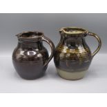 Two Winchcombe Pottery jugs, each with a brown glaze, heights 16.5cm and 15.5cm.