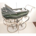 A 1960s Silver Cross pram with green coachwork, single hood and white tyres, full height 50".