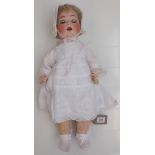 A porcelain head doll by Schoenau and Hoffmeister, the head with sleep eyes, open mouth and teeth,