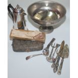 A footed bowl, a coffee pot and a collection of flatware including plate.