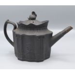 A black basalt teapot, 18th century, the body decorated with a maiden and child,
